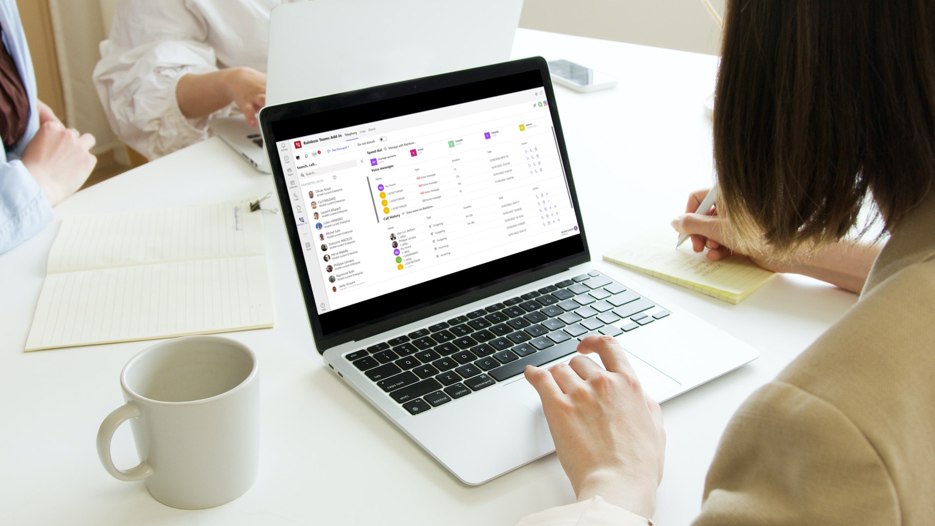 New connector : rainbow telephony for microsoft teams Woman taking notes aside from using the rainbow telephony for microsoft teams